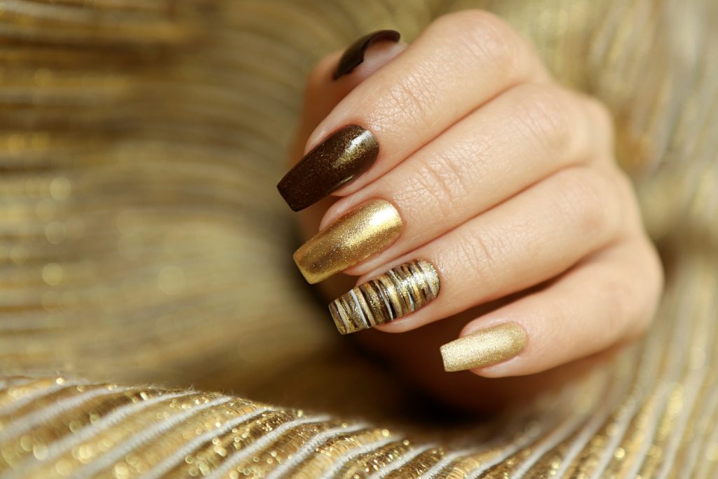 fashionable-manicure-with-matte-golden-color-nail-polish-brown-long-nail-shape